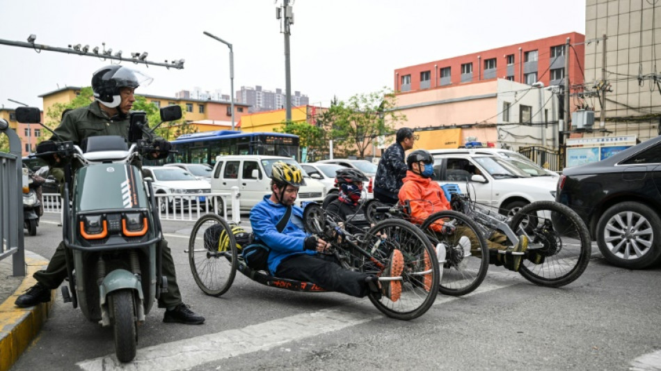 China wheelchair users claim outdoors with hand-cranked bikes