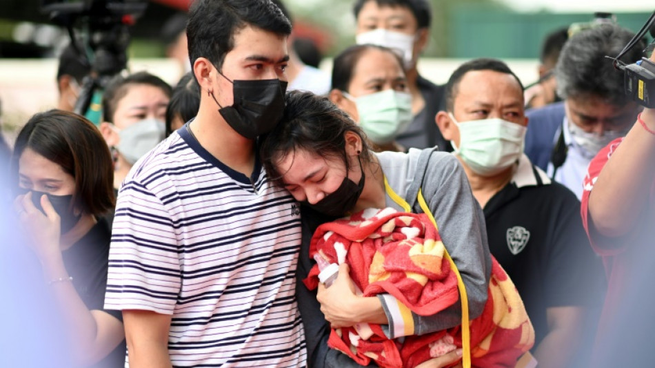 Distraught parents lay white roses for Thai nursery massacre victims