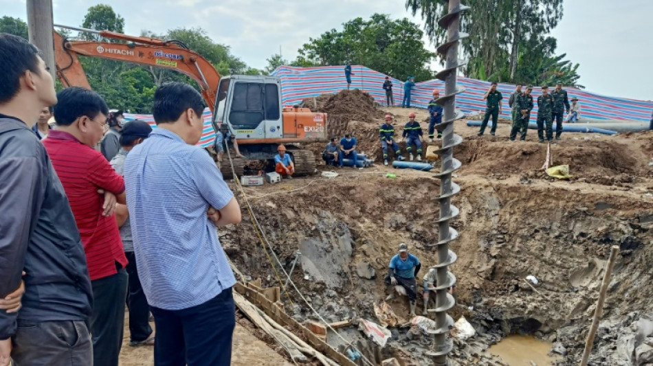 Vietnam rescuers try to raise concrete pillar with trapped boy