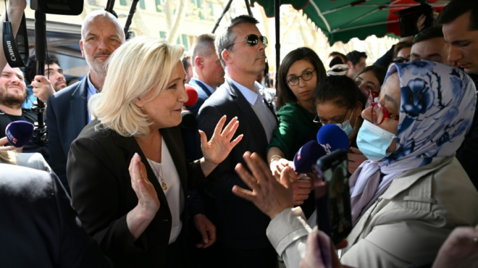 Macron clashes with Le Pen over Islamic headscarf ban